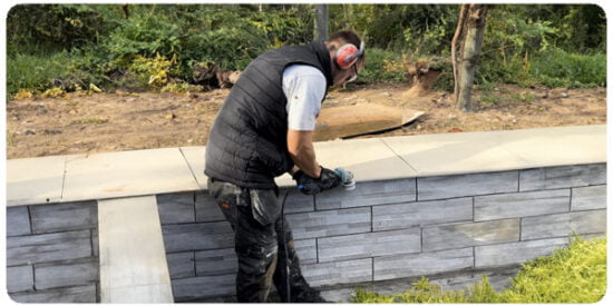 Garden designer constructing a patio wall