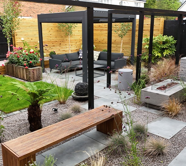 Modern garden pergola above paved patio seating area
